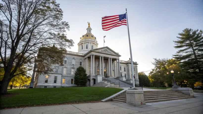 New Hampshire State House building in Concord with American flag